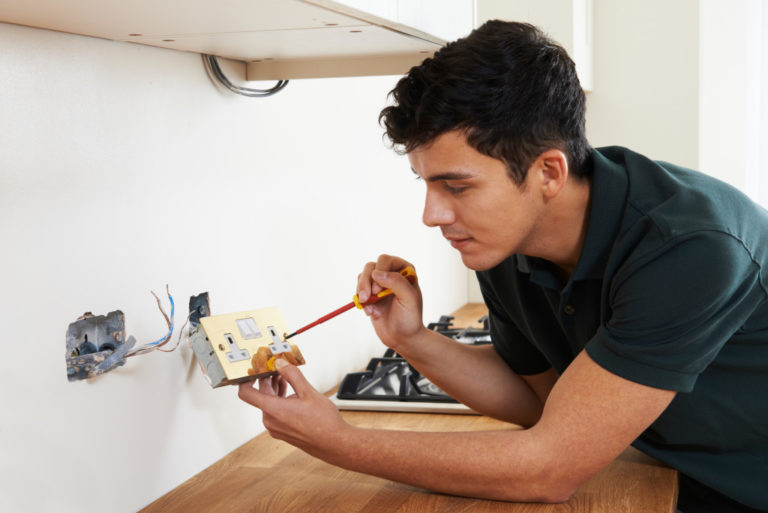 man fixing outlet