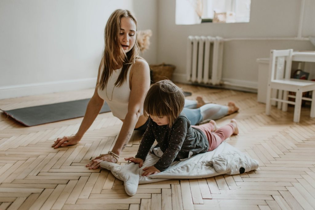 woman and her daughter stretching at home