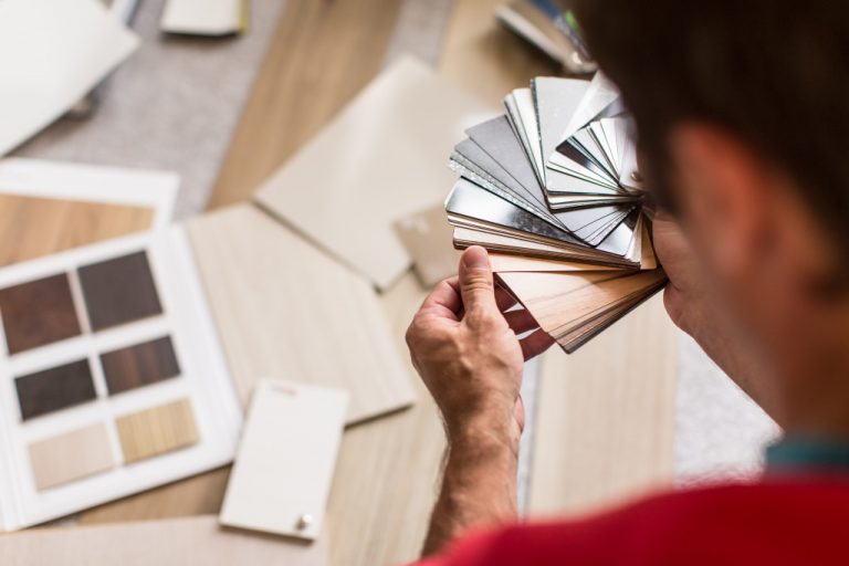 man picking what color and pattern will he use on his flooring
