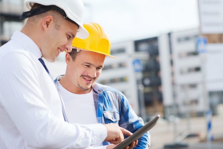 A contractor looking at design plans on a job site